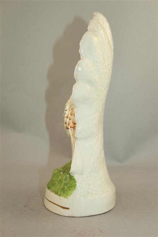 An unusual Staffordshire pottery flatback peacock figure, mid 19th century, 29.5cm.